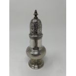 An 18th century silver castor, 13 cm high Marks rubbed 3 ozt