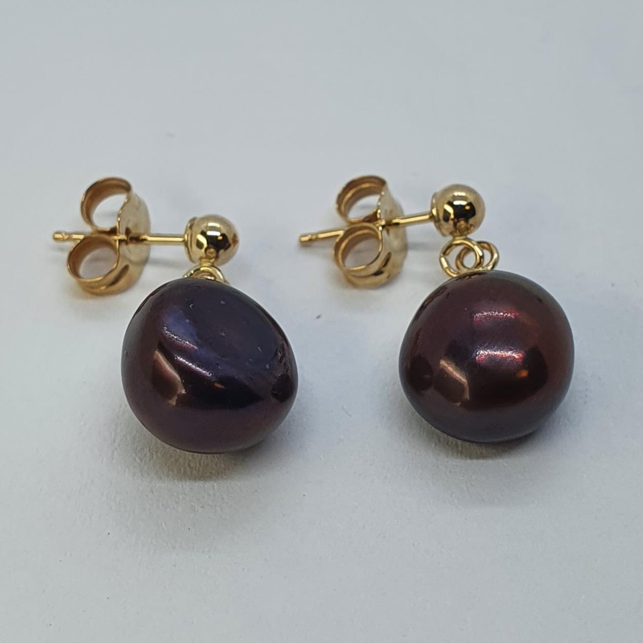 A pair of 9ct gold peach fresh water pearl drop earrings