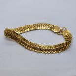 An Indian yellow coloured metal bracelet, stamped KJ 916 20.7 g, untested