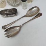 A pair of silver George V salad servers, a mug, a napkin ring, four cut glass bottles with silver