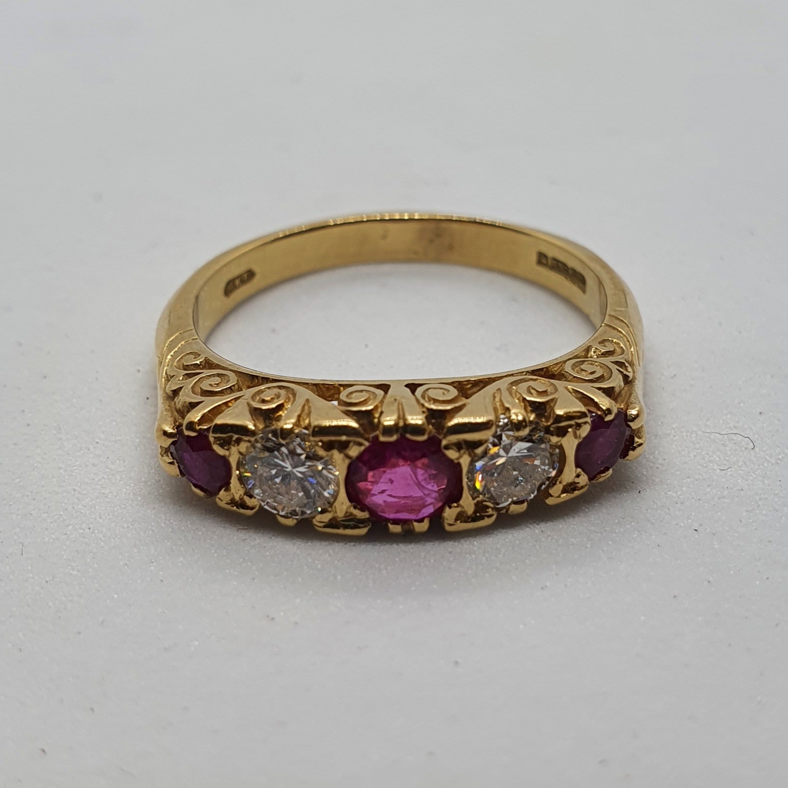 An 18ct gold, diamond and ruby five stone ring, ring size P 1/2 5.8 g all in overall condition