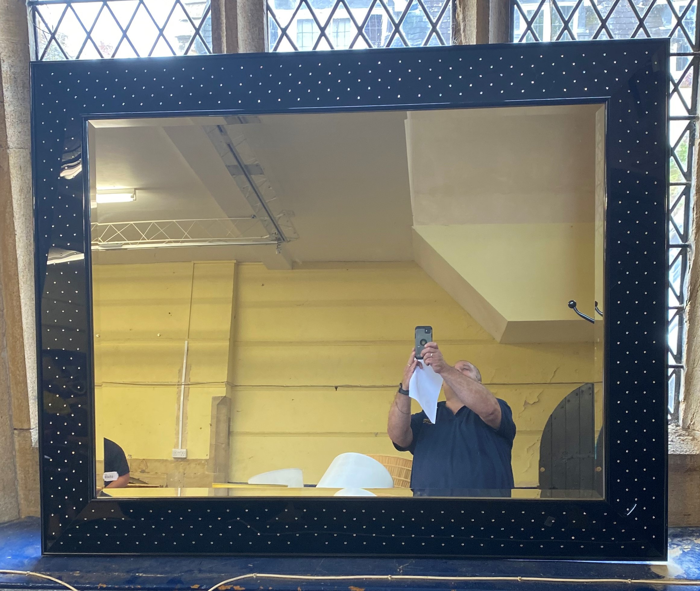 A modern mirror, with black frame inset with crystals/paste, 152 x 124 cm some losses