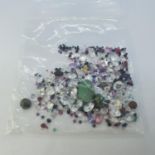 Various loose mixed stones, including cubic zirconia, amethyst, ruby, emerald, jade and sapphire