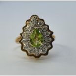 A 14ct gold, peridot and diamond set ring, ring size M