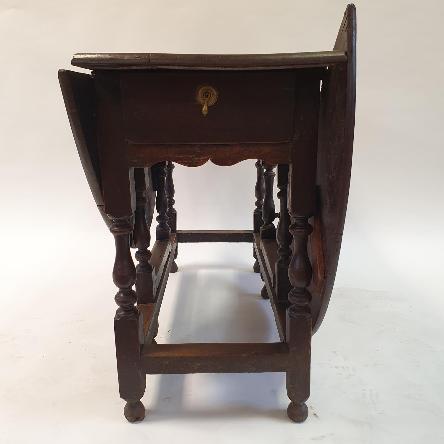 An 18th century oak gateleg table, 114 cm wide, and a walnut lamp table, 67 cm wide and a dressing - Image 2 of 7