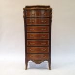 A 20th Century continental chest, of seven drawers, with a marble top and gilt metal mounts, 57 cm