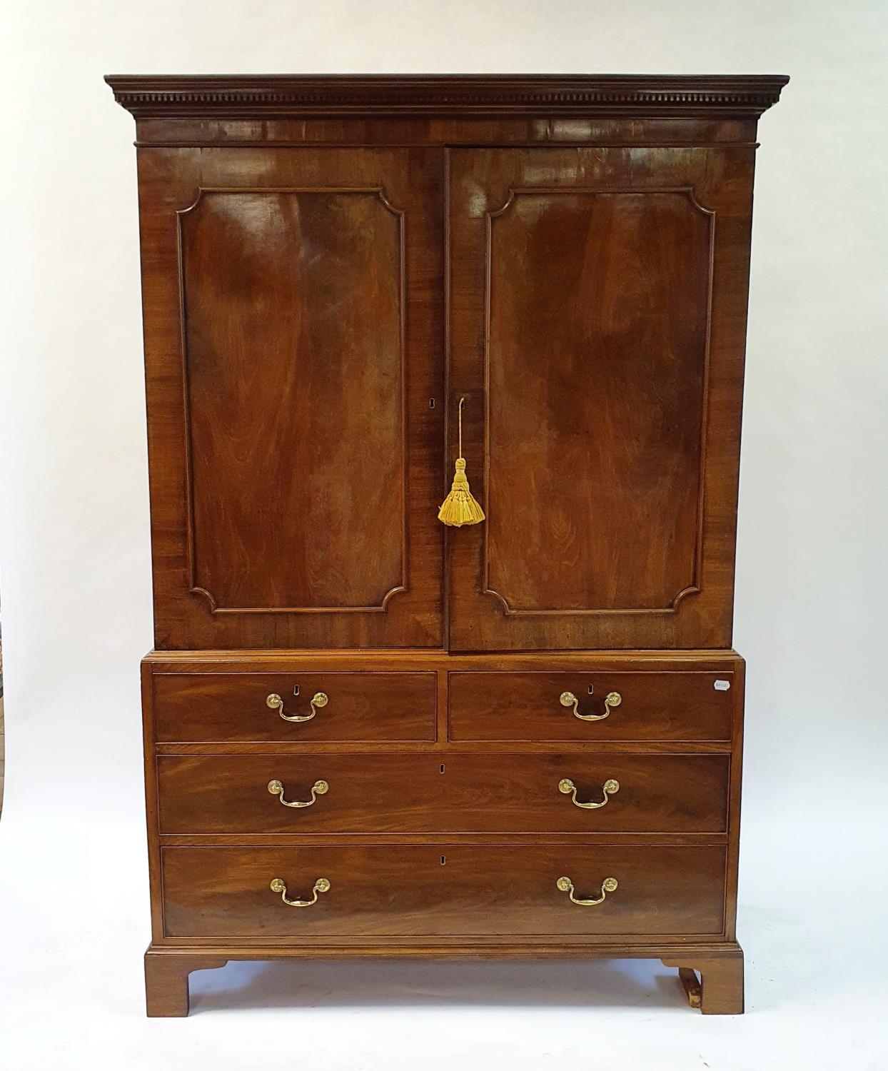 A 19th century mahogany linen press, the top with two cupboard doors, to reveal slides, on a base