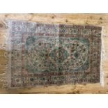 A Persian cream ground silk rug, multiple borders centre with repeating foliate forms, 98 x 62 cm