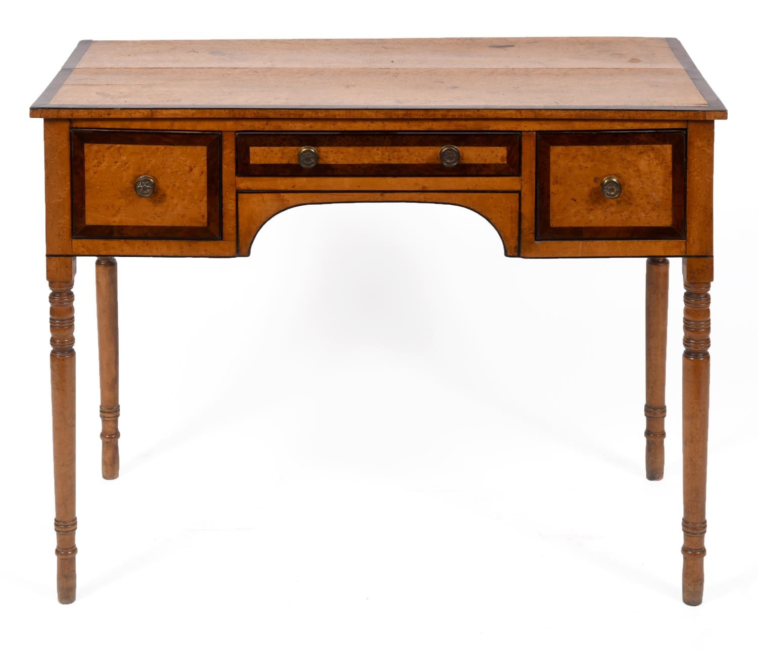 A 19th century kneehole desk, veneered in birdseye maple, having three drawers, on turned tapering