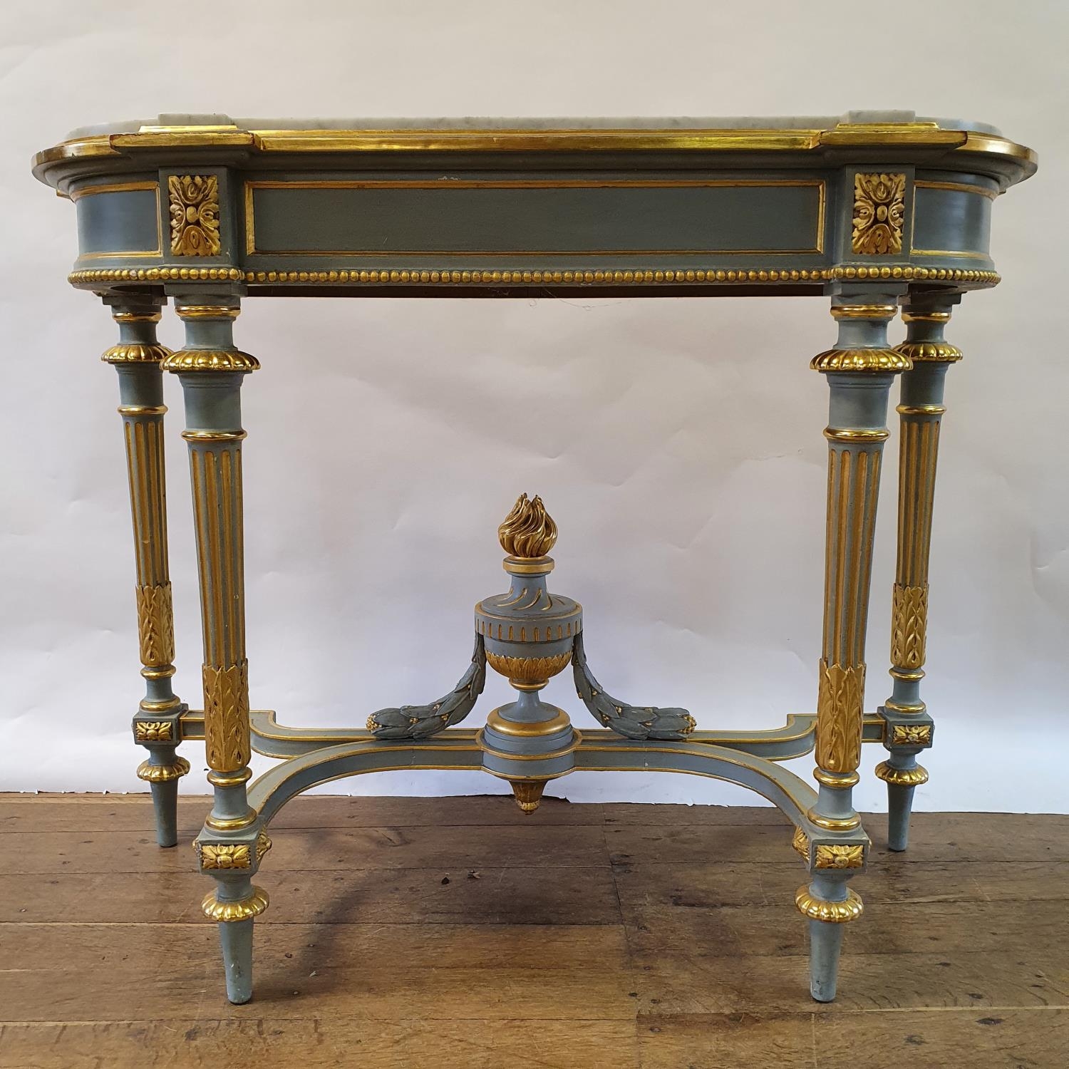 A 19th century style painted console table, with a marble top, on carved, turned and reeded legs