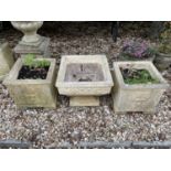 A pair of composite stone square garden planters, 39 cm wide and another on square foot, 48 cm