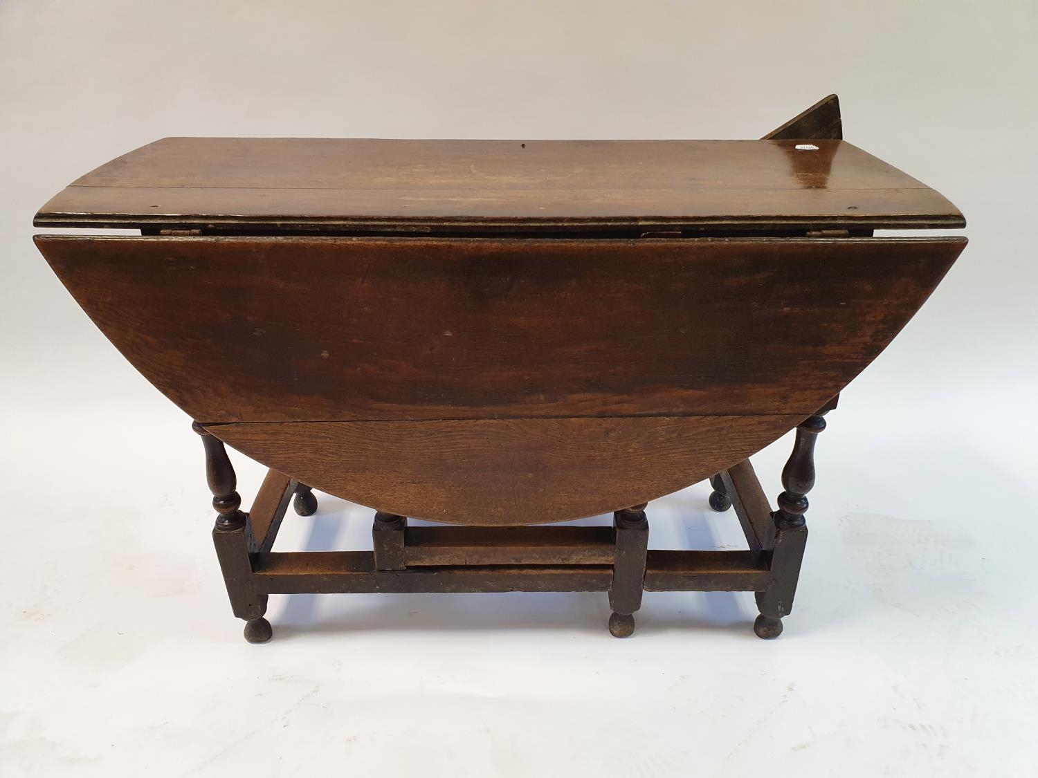 An 18th century oak gateleg table, 114 cm wide, and a walnut lamp table, 67 cm wide and a dressing