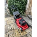 A Lawnflite 991 Sp6 E petrol lawn mower amd a wheel barrow