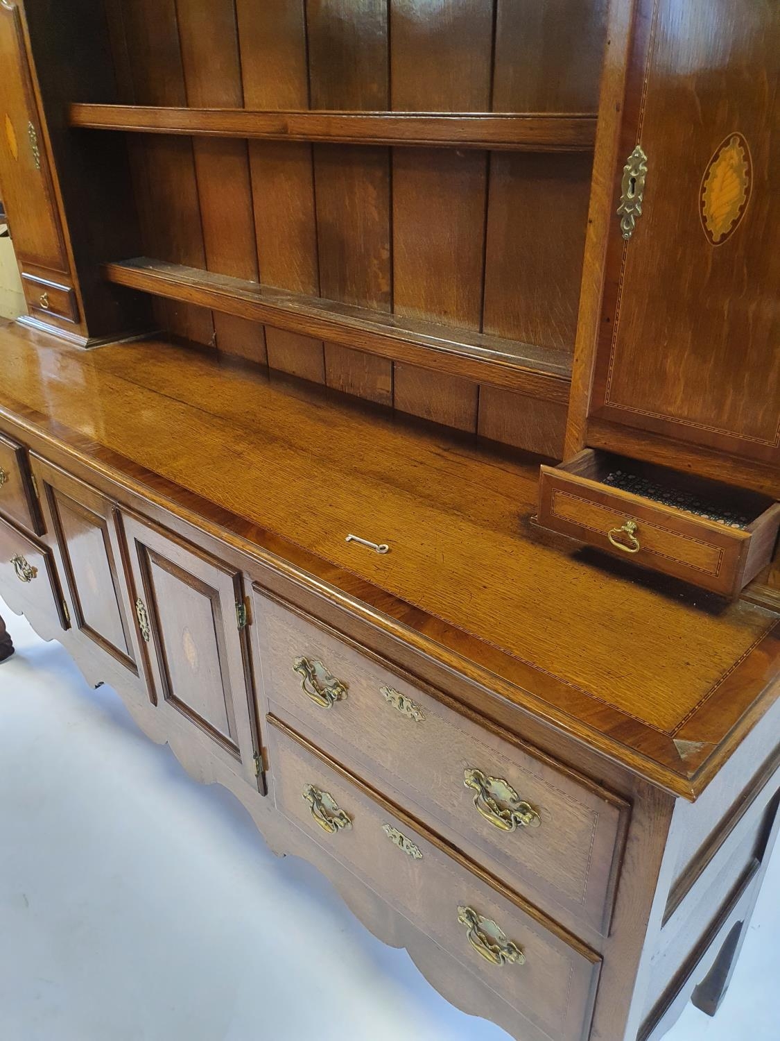 An 18th century style oak dresser, the top with shelves, two cupboard doors and two drawers, the - Image 7 of 8