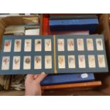Various cigarette cards, postcards, and three stamp albums (3 boxes)
