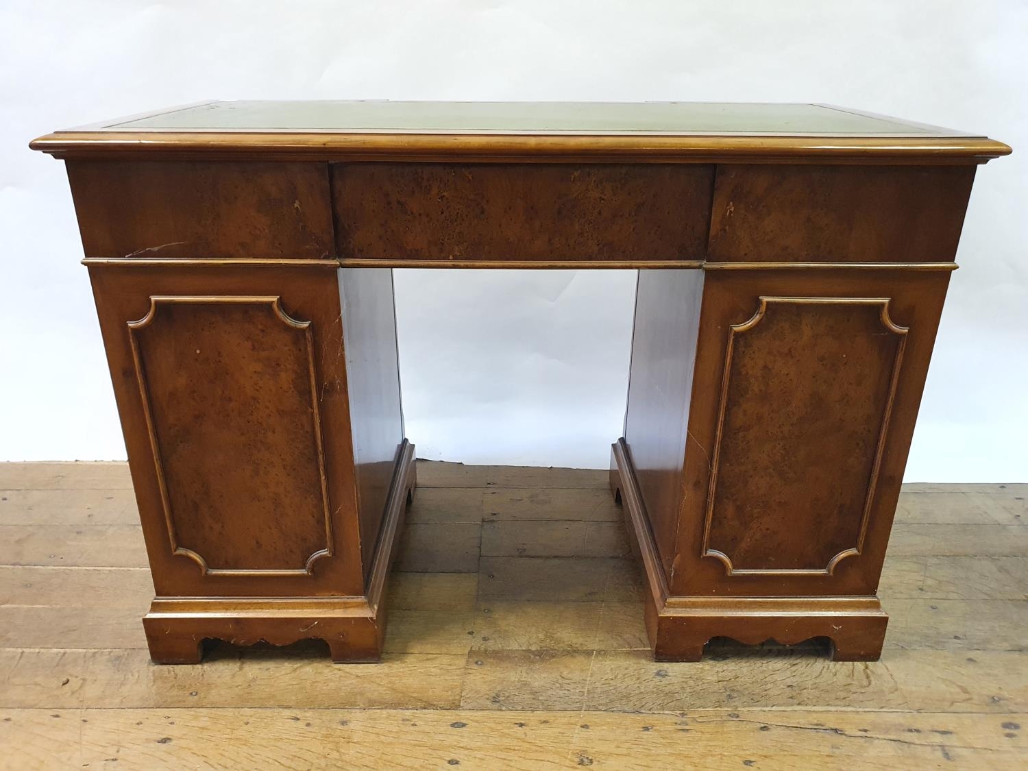 A modern walnut kneehole desk, having nine drawers, 113 cm wide Some small losses and wear to the - Image 6 of 6