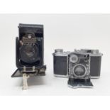 A Zeiss Ikon Super Nettel folding camera, with outer leather case, and a Deltax folding camera, with