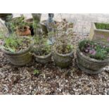 A composite stone garden planter, 35 cm diameter and three other garden planters (4)