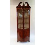 A George III style mahogany bow front free standing corner cupboard, with two glazed doors, above