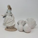 A Lladro figure, of a woman, 26 cm high, a Lladro group of a pair of doves, two Lladro figures,