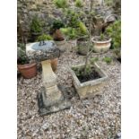 A composite stone garden sundial, 81 cm high and a composite stone garden planter, 43 cm wide