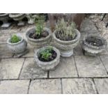 A pair of composite stone garden planters, on octagonal bases, 46 cm diameter, another pair and a