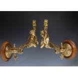 A pair of late 19th/early 20th century brass gas wall lamps, in the form of maidens holding torches,