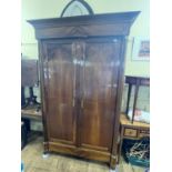 A 19th century French armoire having two cupboard doors, flanked by column supports with gilt