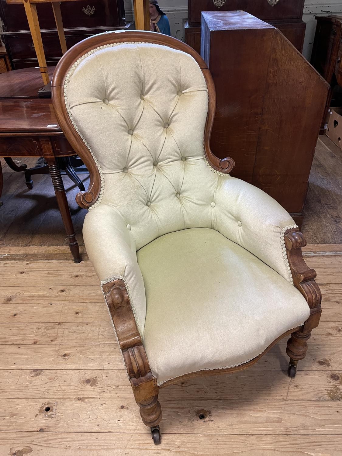 A 19th century mahogany button back arm chair