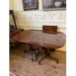 A George III style mahogany twin pillar, tilt top dining table, inset an extra leaf, 132 x 95 cm,