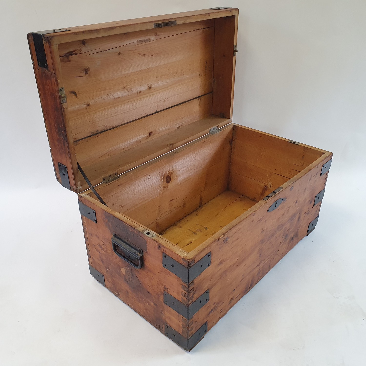 A pine and metal bound trunk, with paper labels for London to Bombay, 85 cm wide