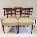 A set of five 19th century mahogany bar back dining chairs, with padded seats, on square tapering