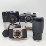 an Olympus GM 10 camera with a Vivitar Series 1 lens, a Halina 6-4 camera in leather case and a