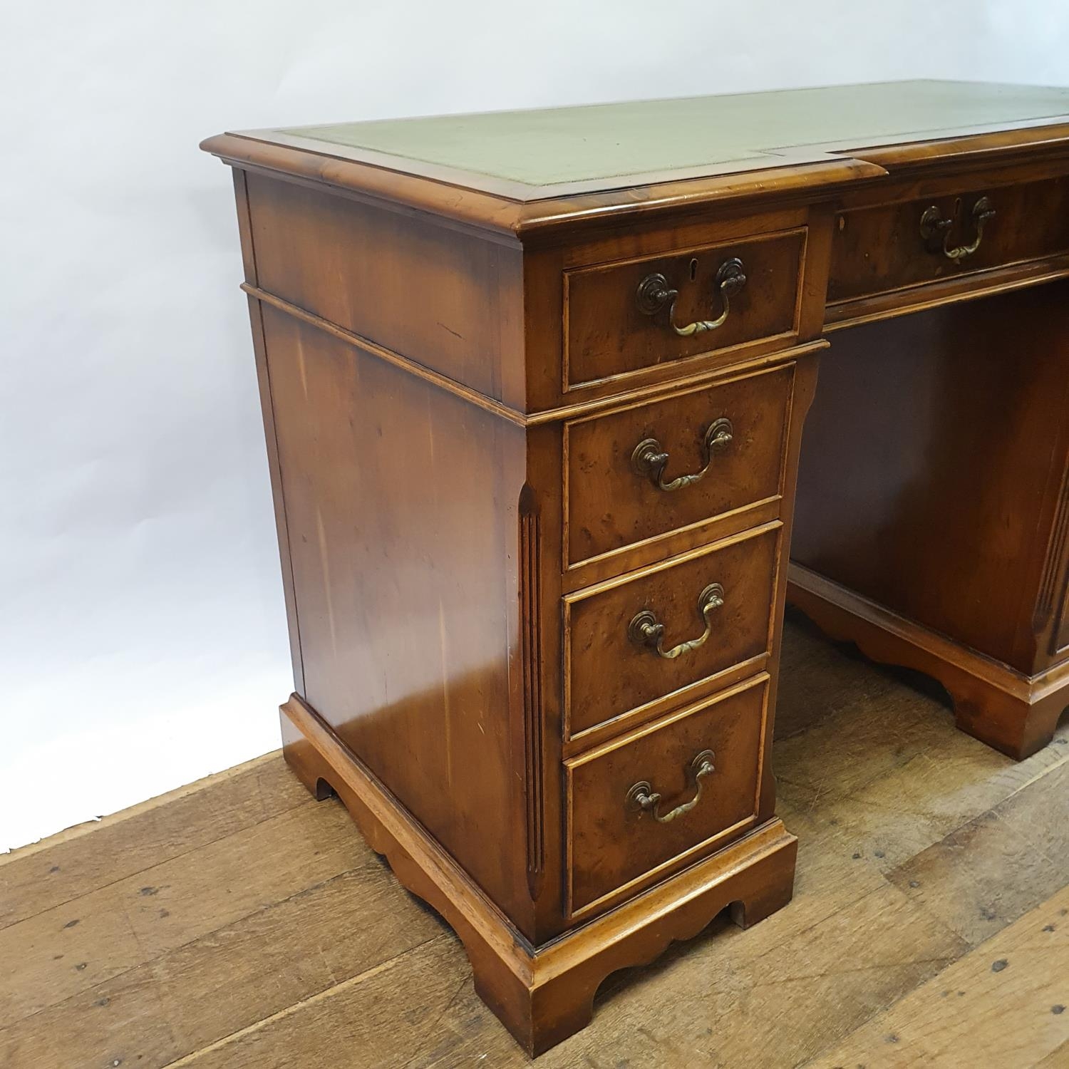 A modern walnut kneehole desk, having nine drawers, 113 cm wide Some small losses and wear to the - Image 4 of 6