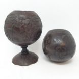 A 19th century carved coconut, on shaped foot, 20 cm high, and another (2)
