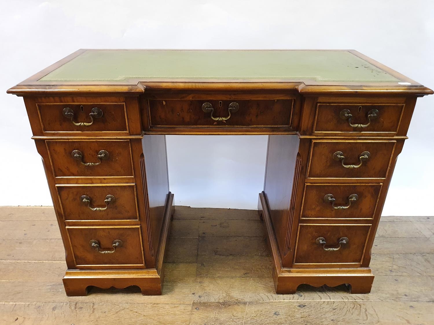 A modern walnut kneehole desk, having nine drawers, 113 cm wide Some small losses and wear to the - Image 2 of 6