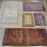 A pink ground prayer mat, 94 x 67 cm, and four other rugs (4)