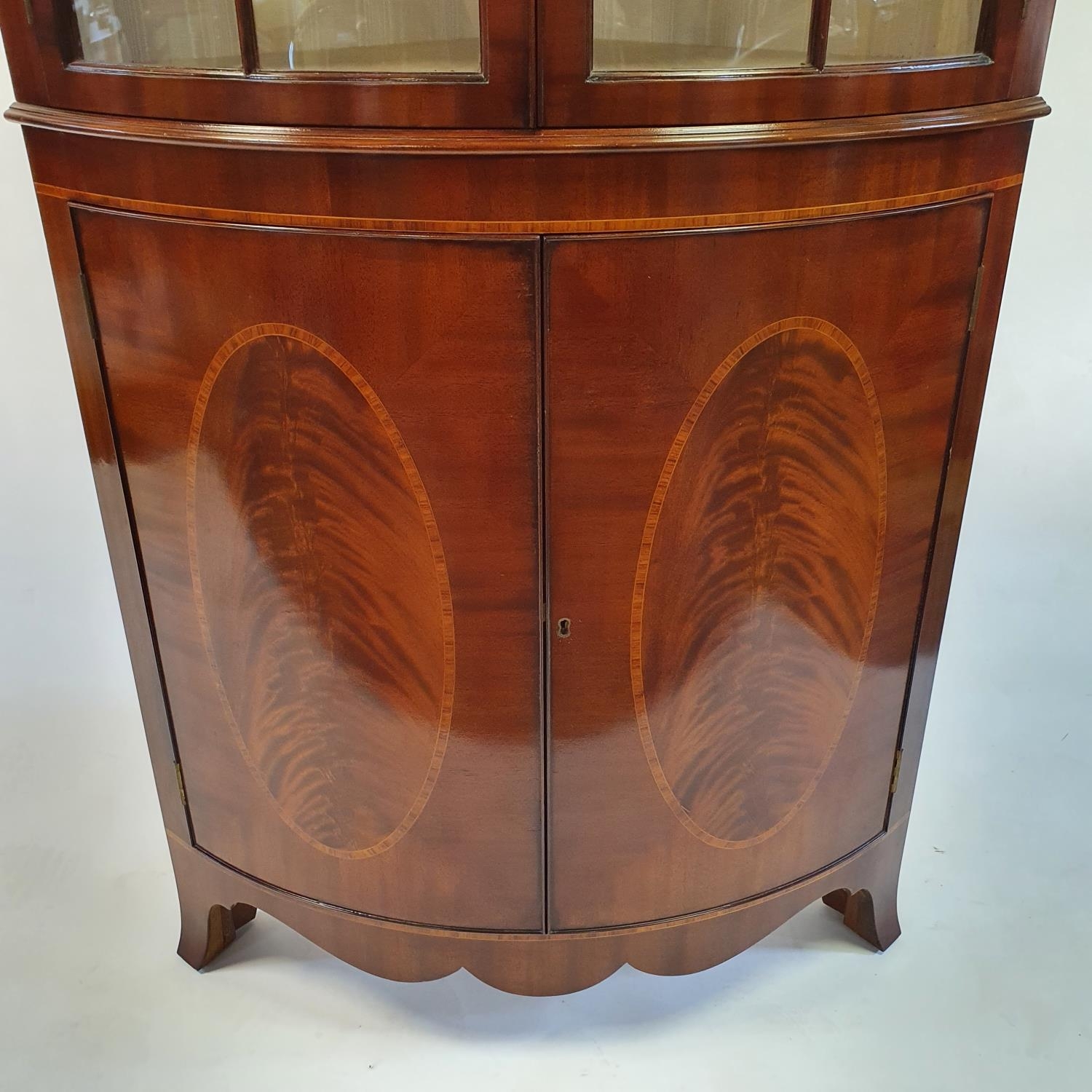 A George III style mahogany bow front free standing corner cupboard, with two glazed doors, above - Image 2 of 4