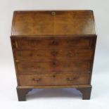 A 19th century walnut fall front bureau, having a fitted interior, above four graduated drawers,