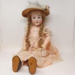 An Armand Marseille bisque head doll, with sleeping blue eyes and four exposed teeth, impressed