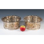 A pair of large silver plated coasters, with pierced decoration, border with vine leaves and grapes,