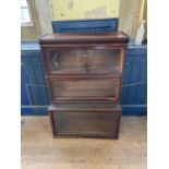 A mahogany Globe Wernicke three section bookcase Lacking base deep drawer also lacking mounts