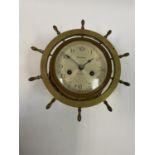 A ships clock, signed, Waterbury, in brass case 23 cm diameter