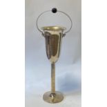 A silver plated floor standing champagne bucket, with ring handle inset with ebonised knop, 88 cm