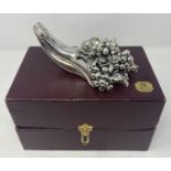 A silver plated paperweight, in the form of a cornucopia filled with grapes, 17 cm wide, boxed