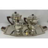 A French Art Deco silver plated four piece tea and coffee service, including tray, with rosewood