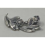 A silver floral brooch by Bernard Instone