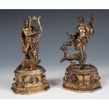 A pair of 18th/19th century Continental silver gilt figures of Artemis and Apollo, on floral