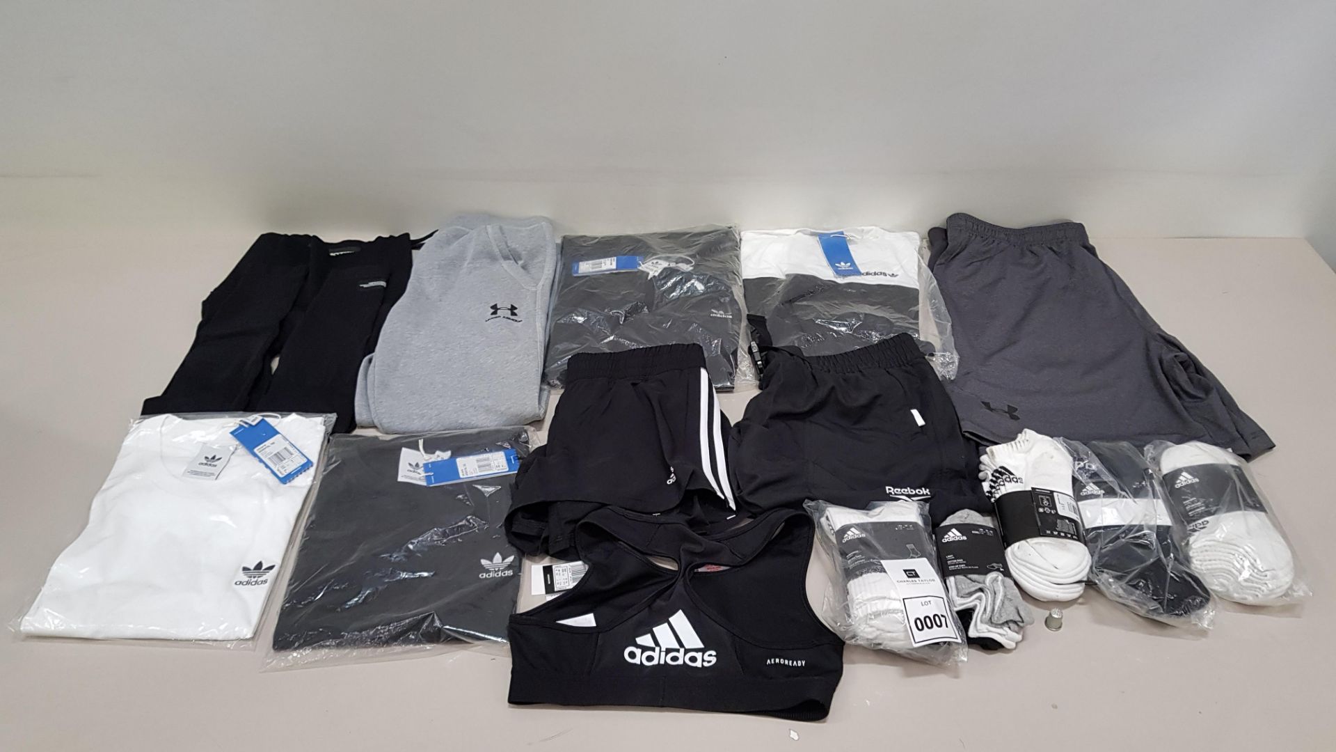 15 PIECE CLOTHING LOT CONTAINING ADIDAS SOCKS, UNDER ARMOUR PANTS, ADIDAS T SHIRTS, REEBOK SHORTS