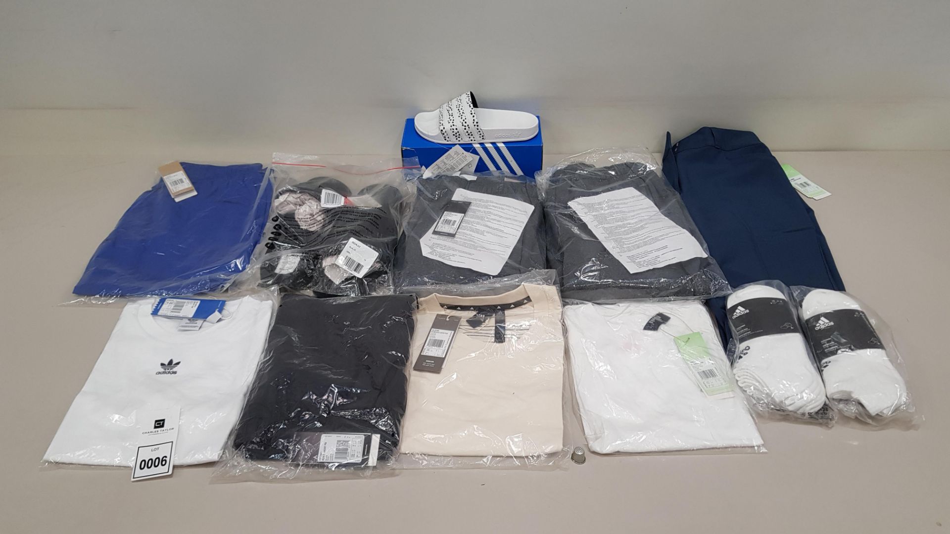 12 PIECE CLOTHING LOT CONTAINING ADIDAS SLIDERS, ADIDAS SWEATPANTS, ADIDAS SHORTS, ADIDAS PANTS